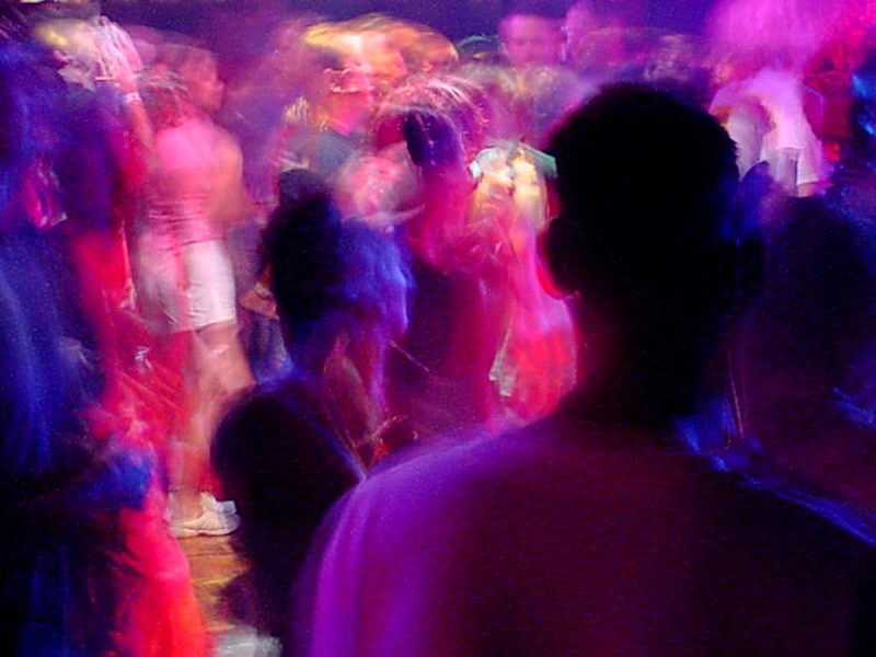 Long-exposure photograph of dancers at a rave