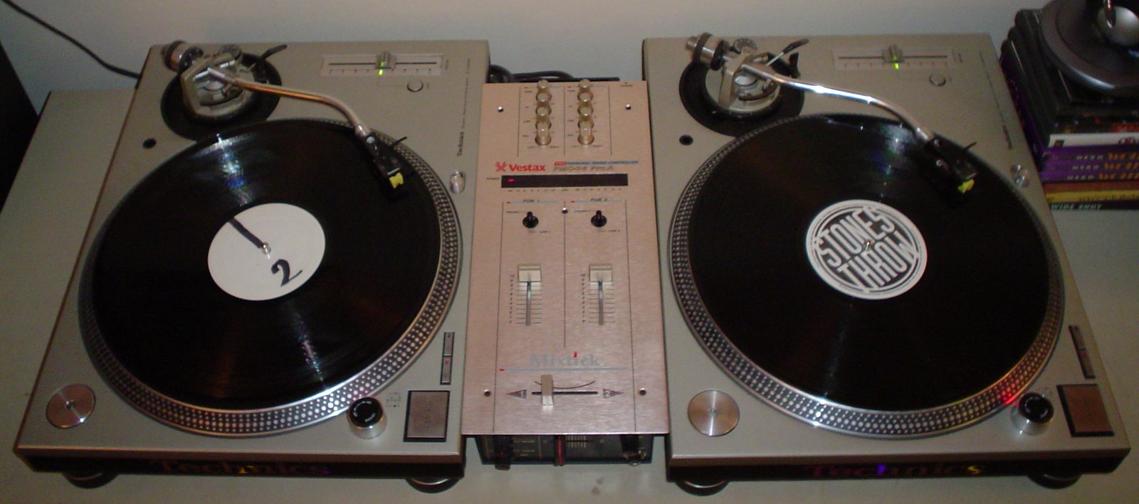 Pair of Technics turntables and a DJ mixer with vinyl records